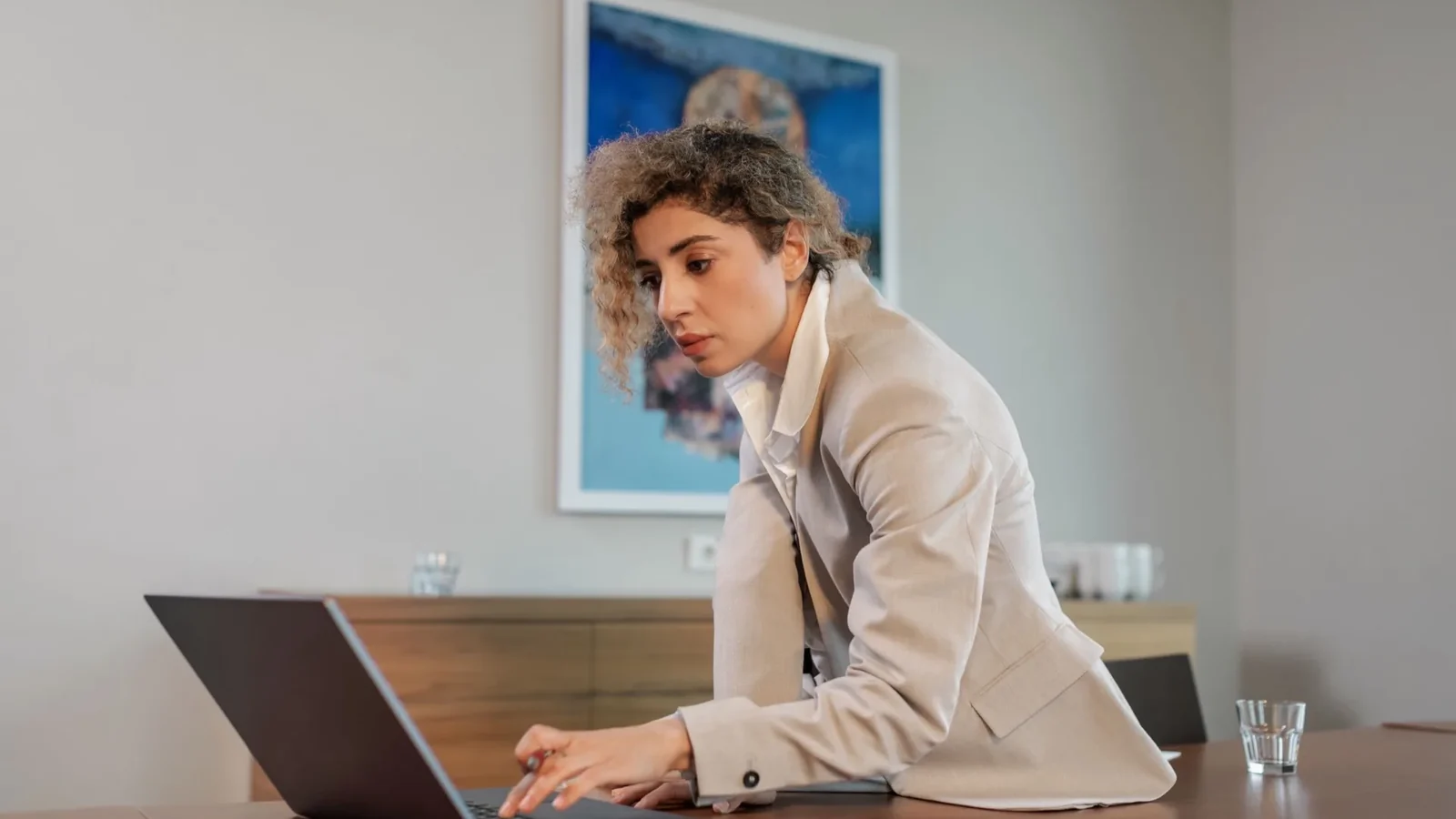 Business owner checking search results on a laptop, representing how AI assistants recommend local service businesses
